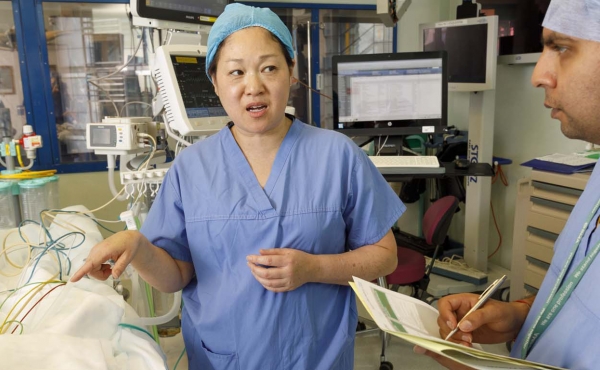 Anaesthetist with patient and colleagues