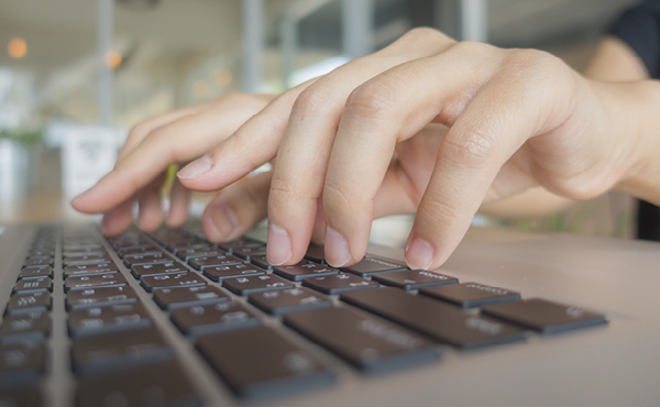 Hand typing on keyboard